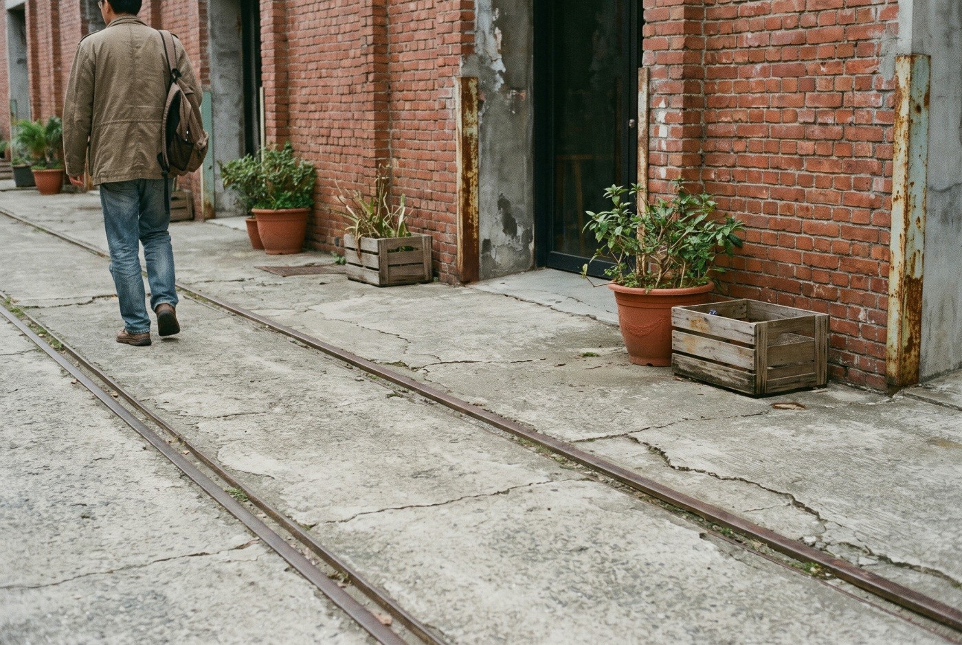 Illustration: A walk past brick buildings and old rails.