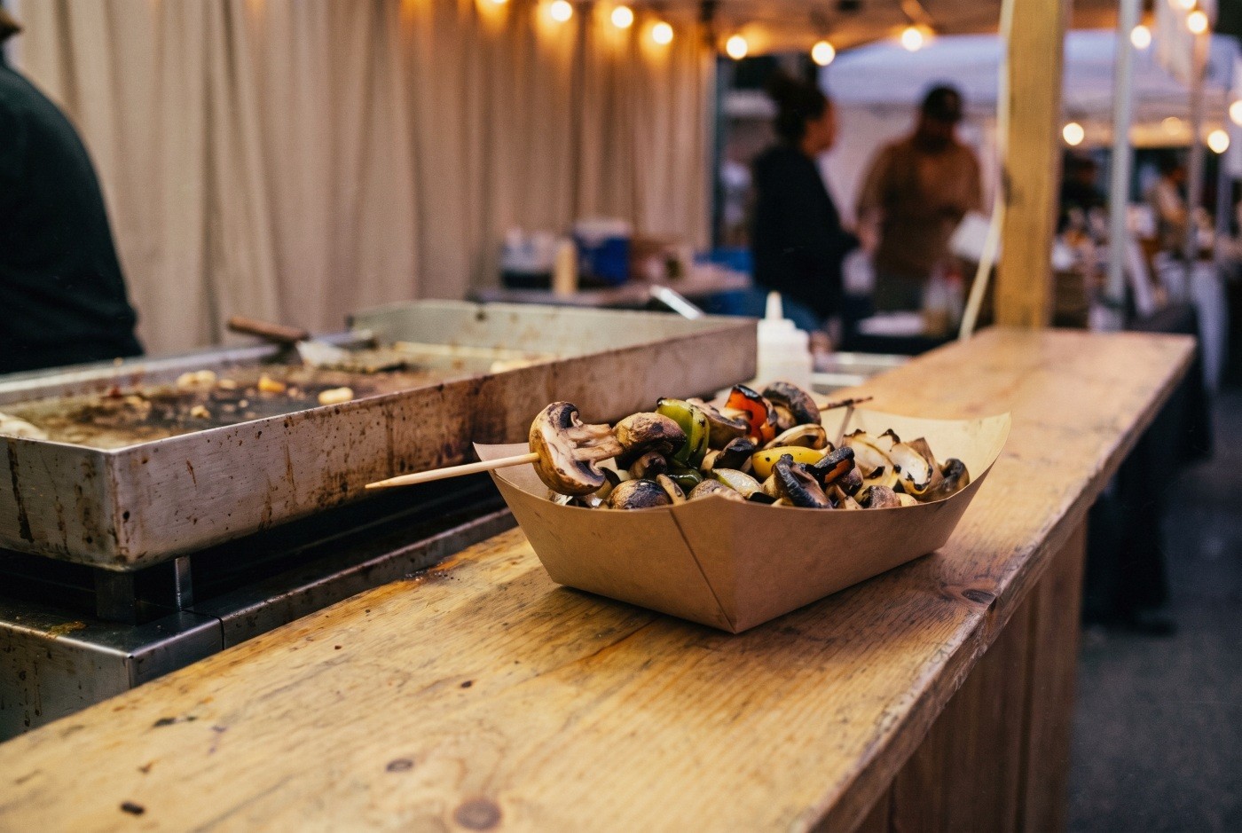 Illustration: A tray of grilled vegetables at a food stall.