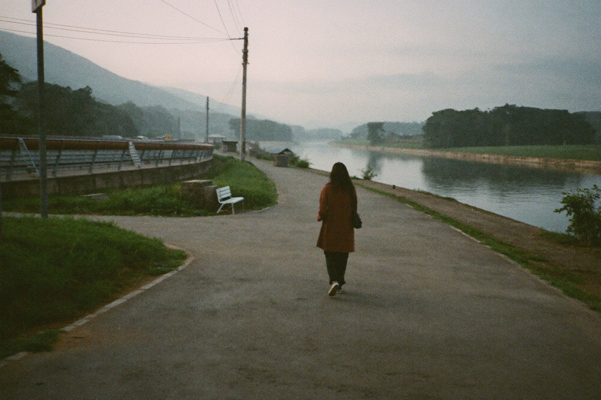 Walking along a riverside path at dawn