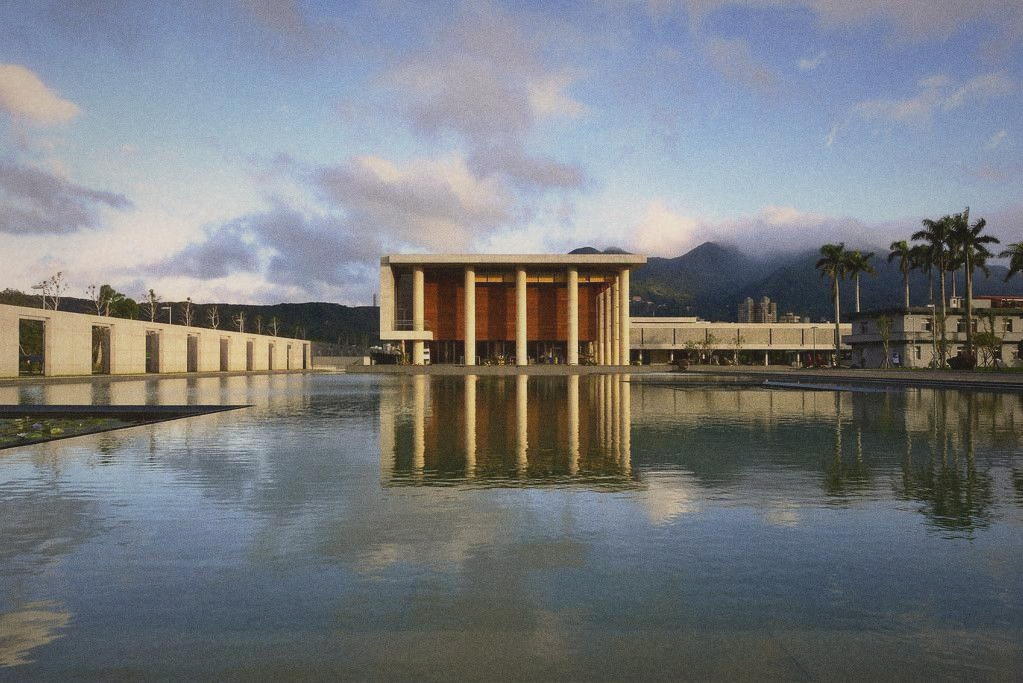 A quiet temple courtyard in the early morning, stone and water, soft light