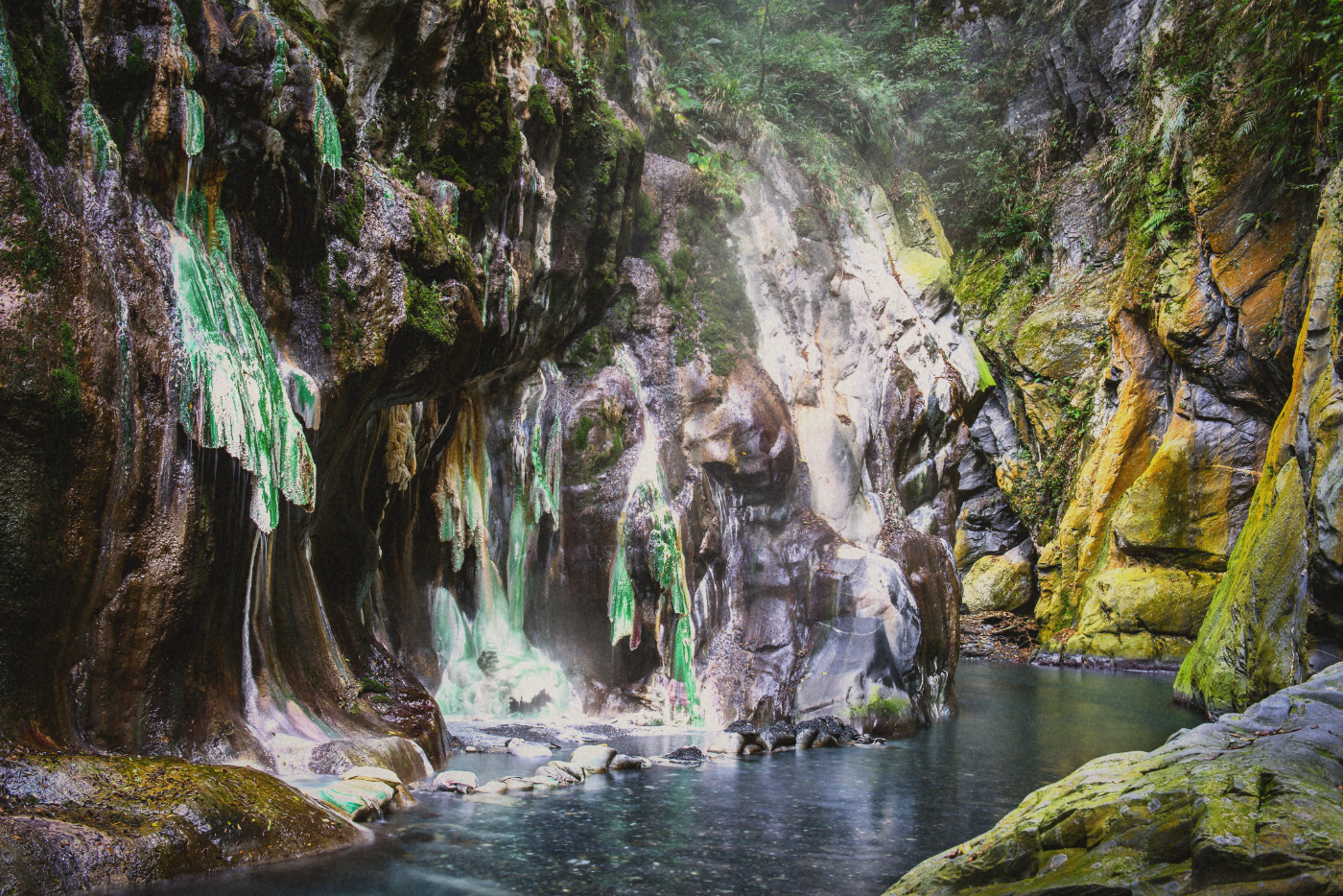 Mineral-stained rock walls at Lisong Hot Spring, photographed in December 2015. Archival image.