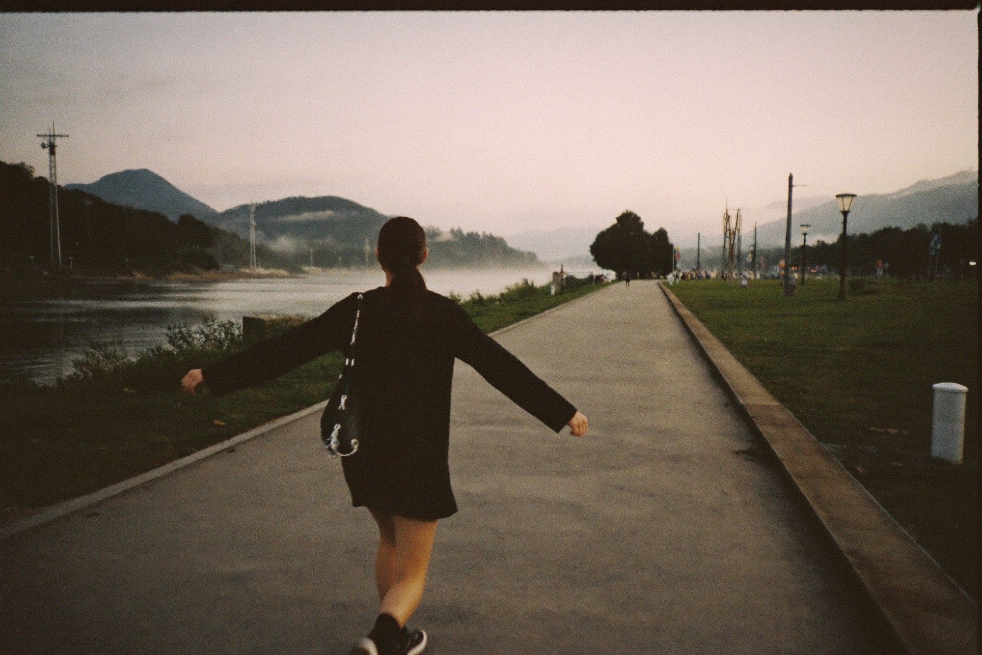 Walking along a riverside path at dawn