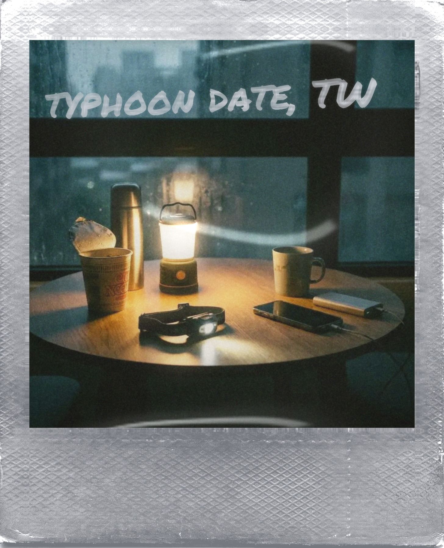 Inside a Taipei apartment during a typhoon power outage: a table lit by an LED lantern with cup noodles, a thermos and a phone charging from a power bank
