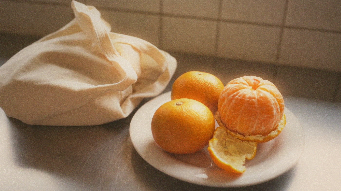 Mandarins on a plate beside a shopping bag