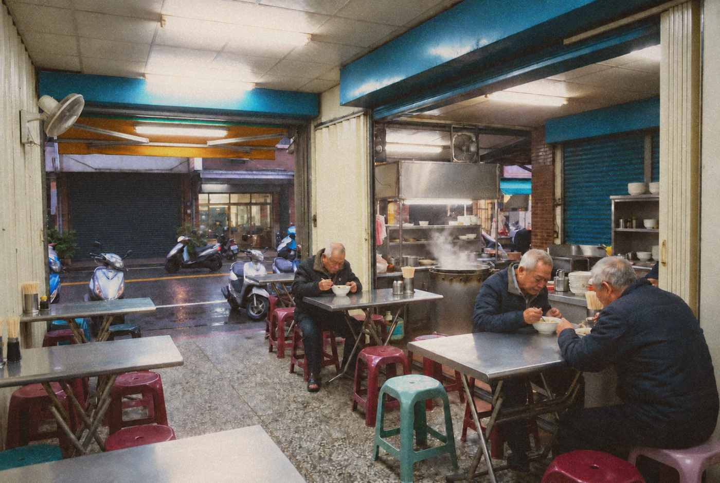 Customers eating soup beneath fluorescent lights in a small Taiwanese shop.