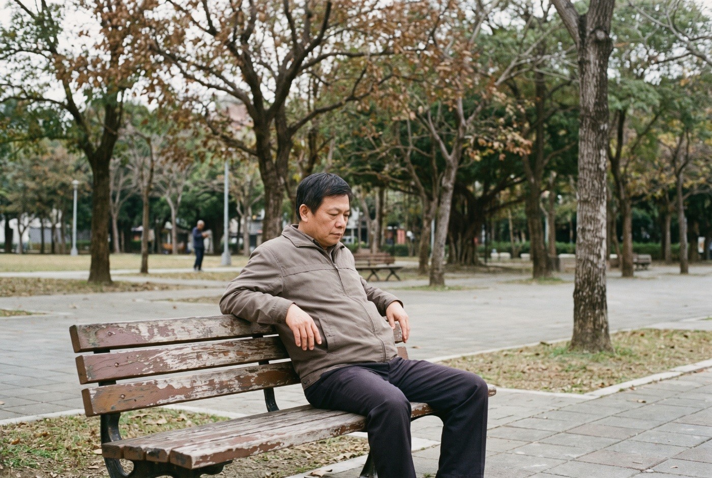 Illustration: A man resting on a park bench.