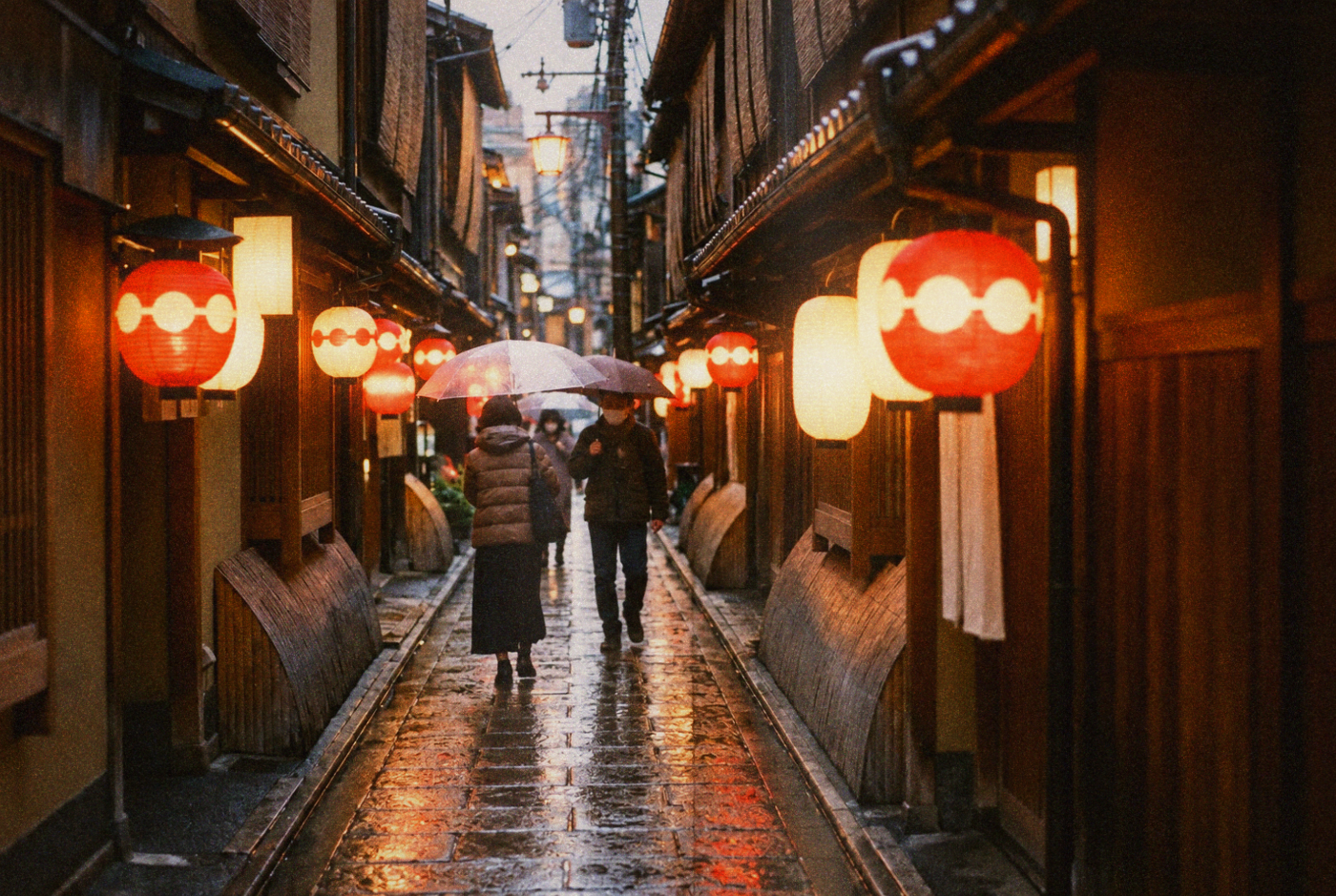 Lantern-lit lane lined with wooden restaurant fronts