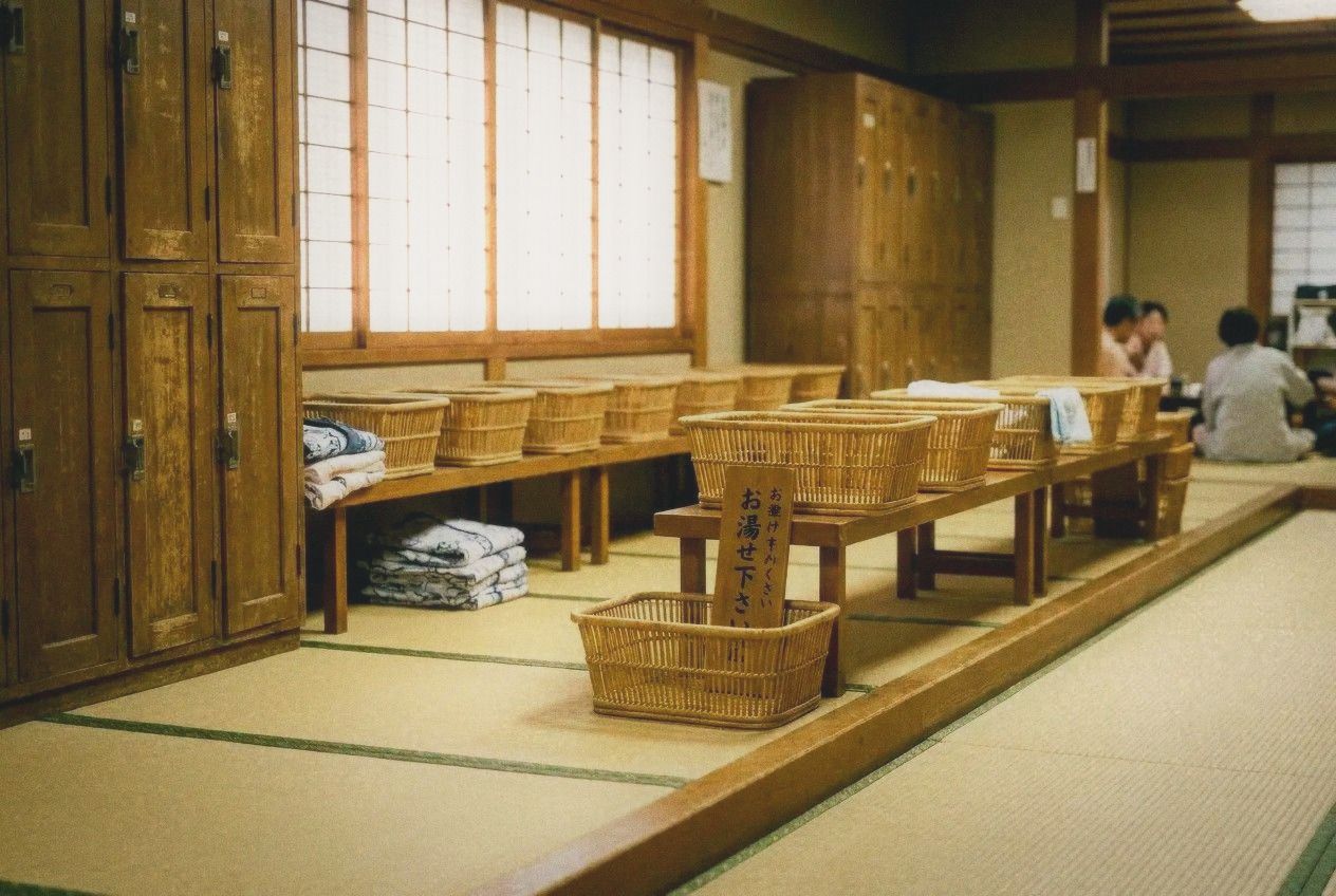 Traditional Japanese onsen changing room with wooden lockers