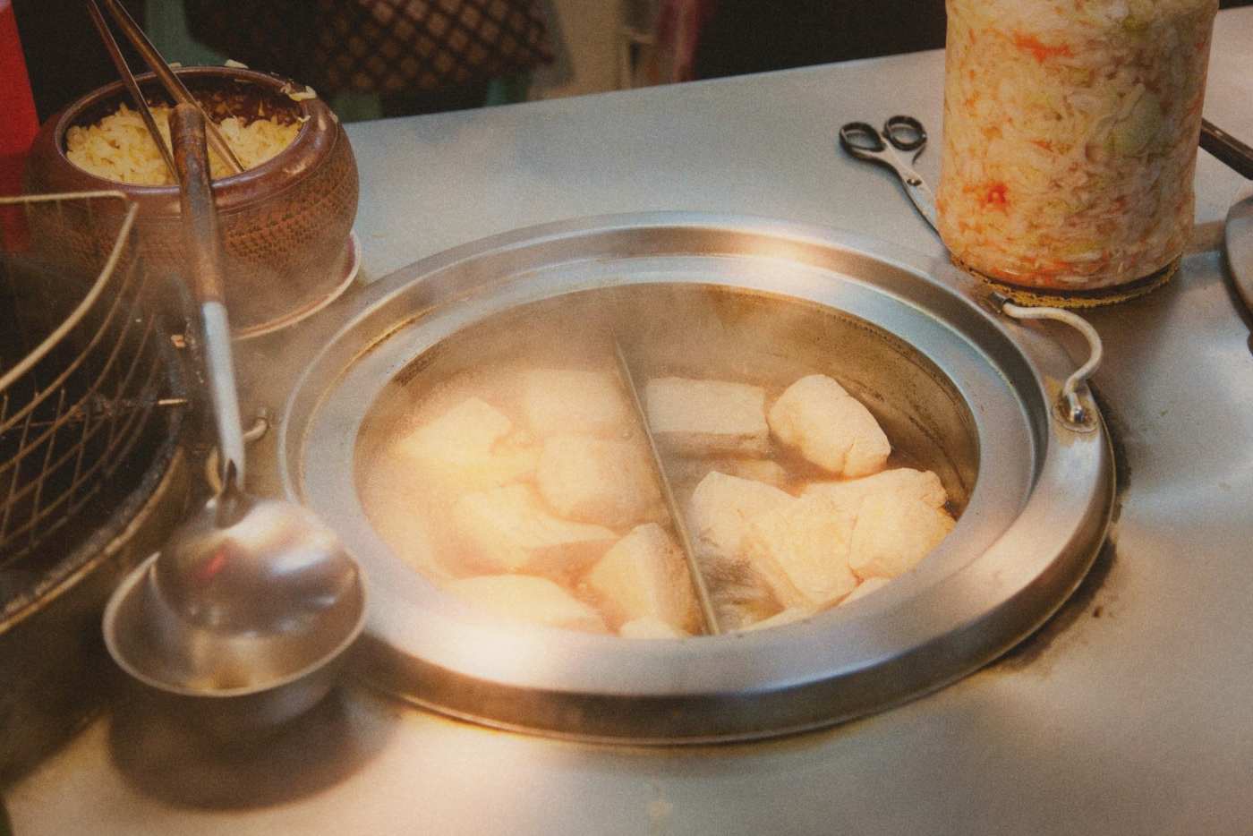 Steamed stinky tofu served in bamboo baskets with pickled vegetables