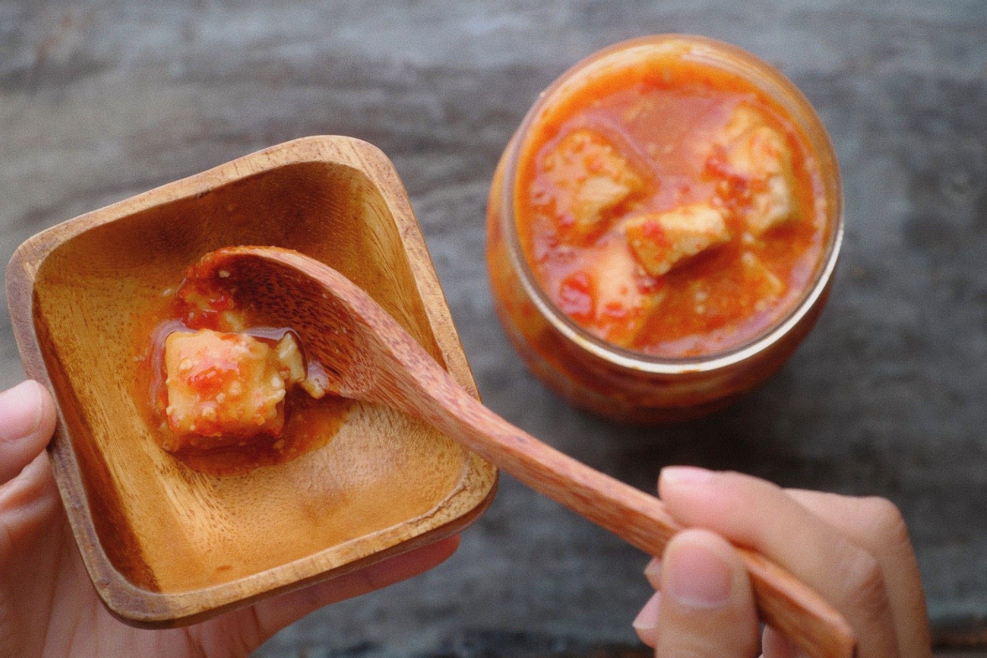 Close-up of fermented tofu cubes in a glass jar