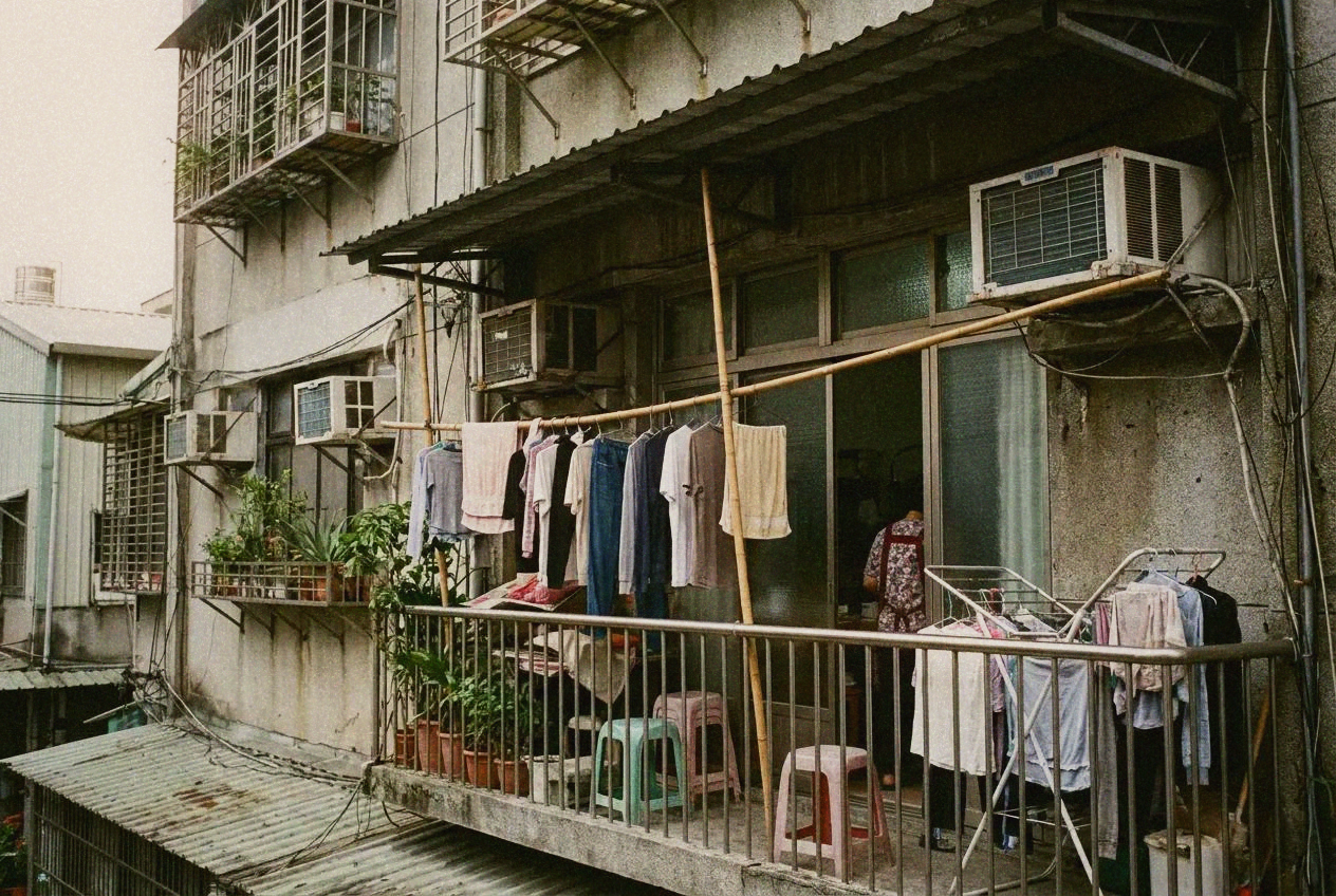 Laundry hanging on a Taipei apartment balcony with city skyline