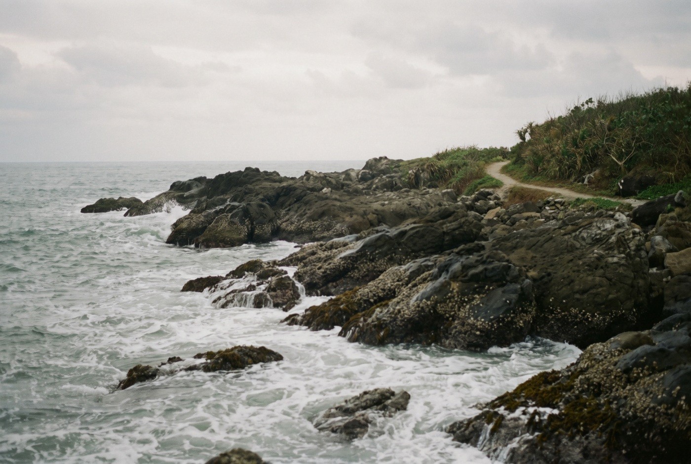 Illustration: Waves breaking along a rocky shore.