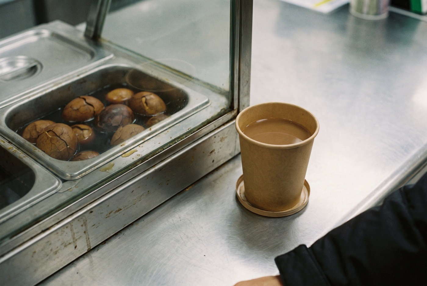 Illustration: Tea eggs and a warm drink at a small counter