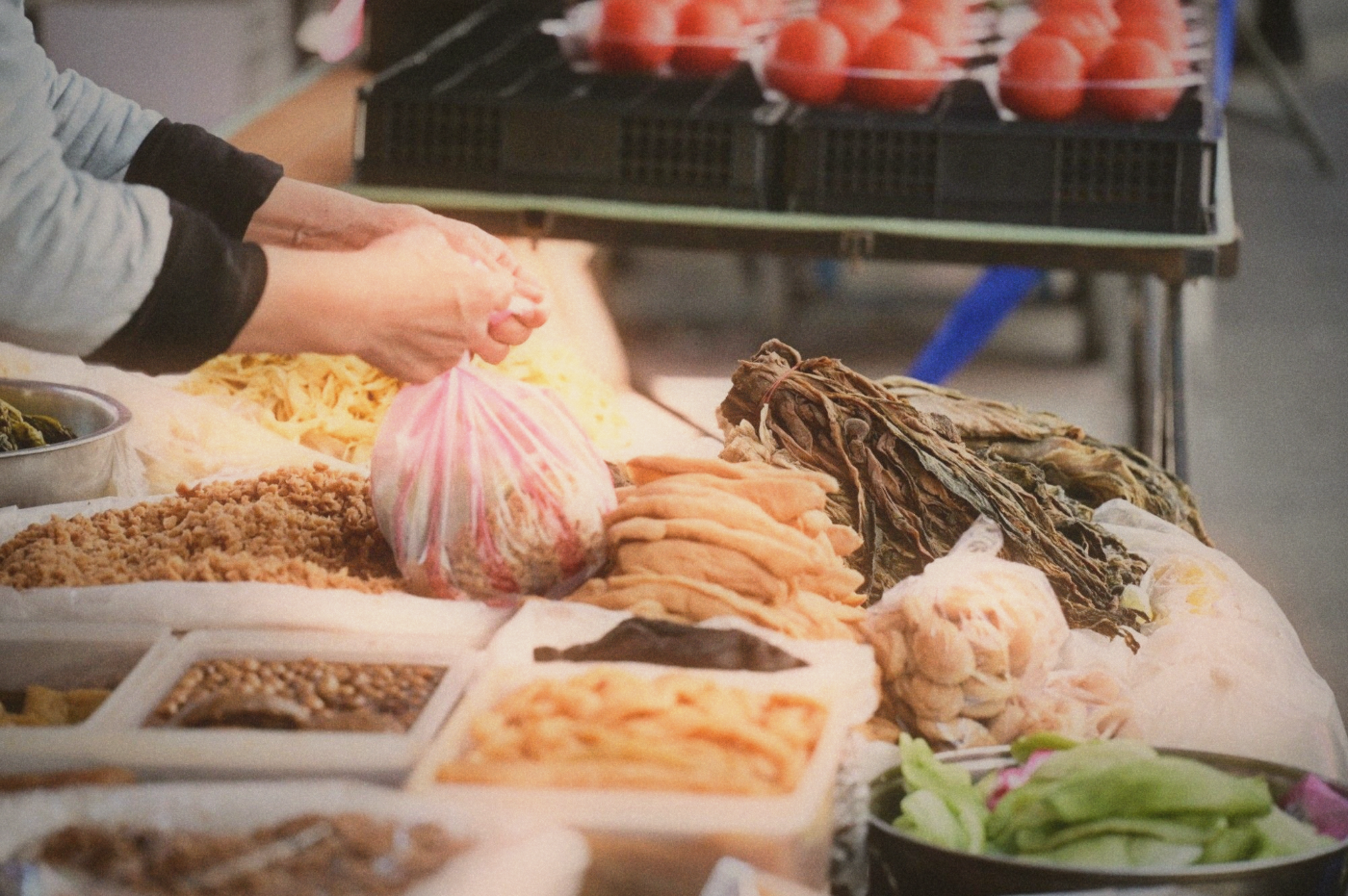 Traditional fermented foods including pickled vegetables and tofu at a market stall