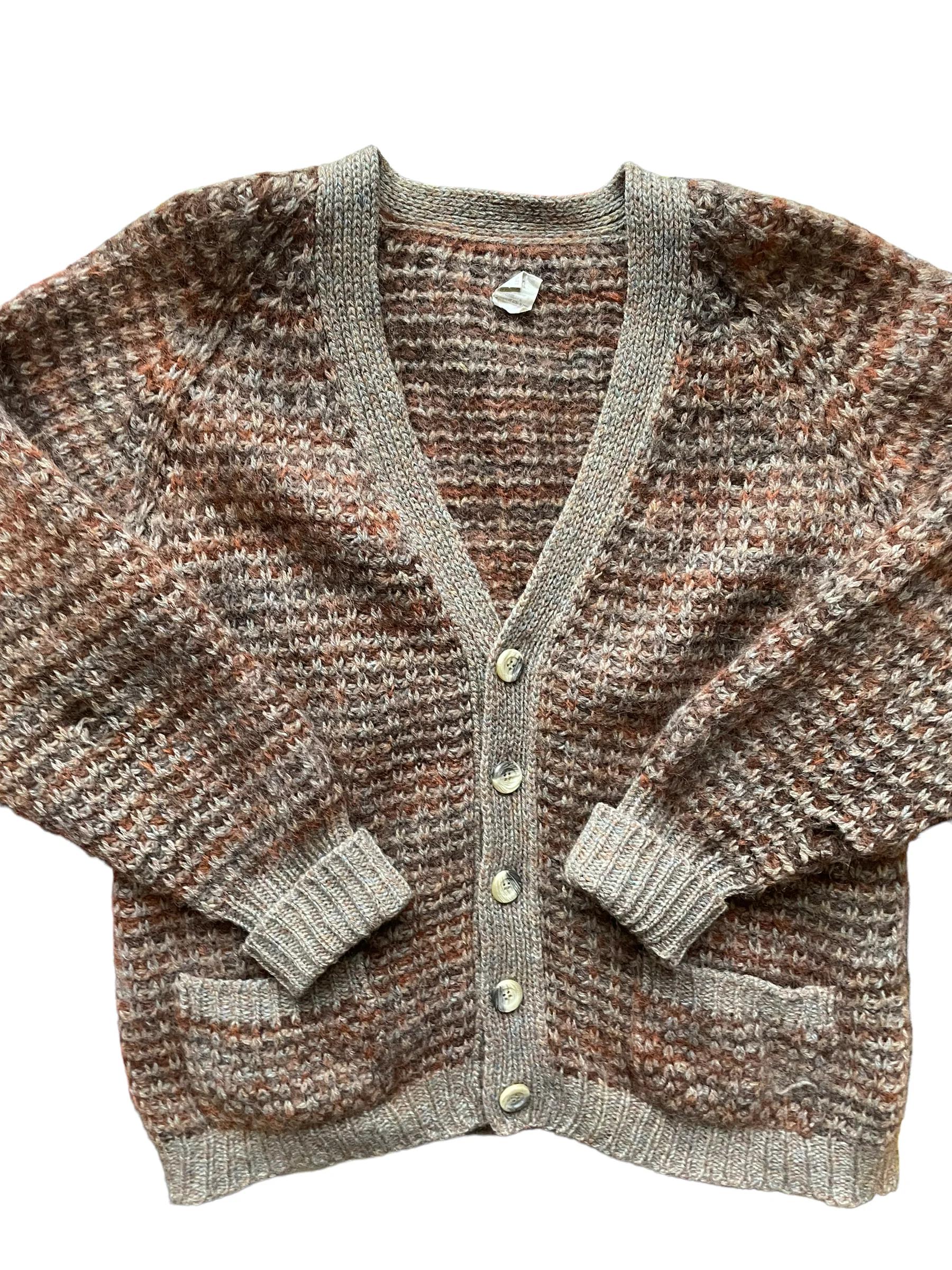 Folded vintage sweaters in warm earth tones