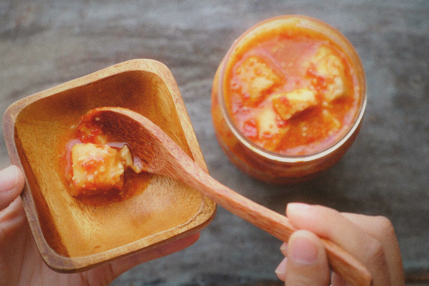 Close-up of fermented tofu cubes in a glass jar