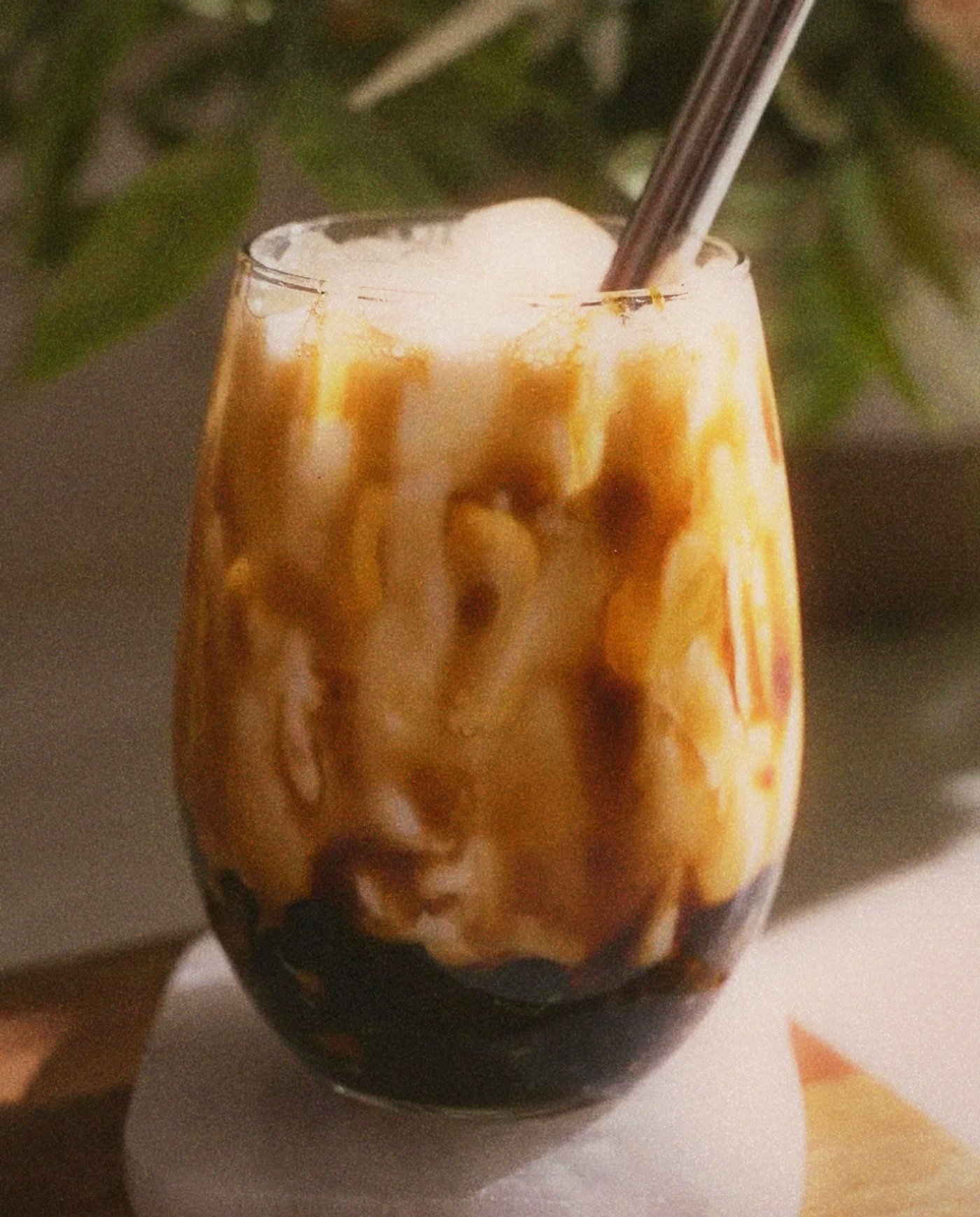 Close-up of brown sugar boba pearls in a cup of fresh milk