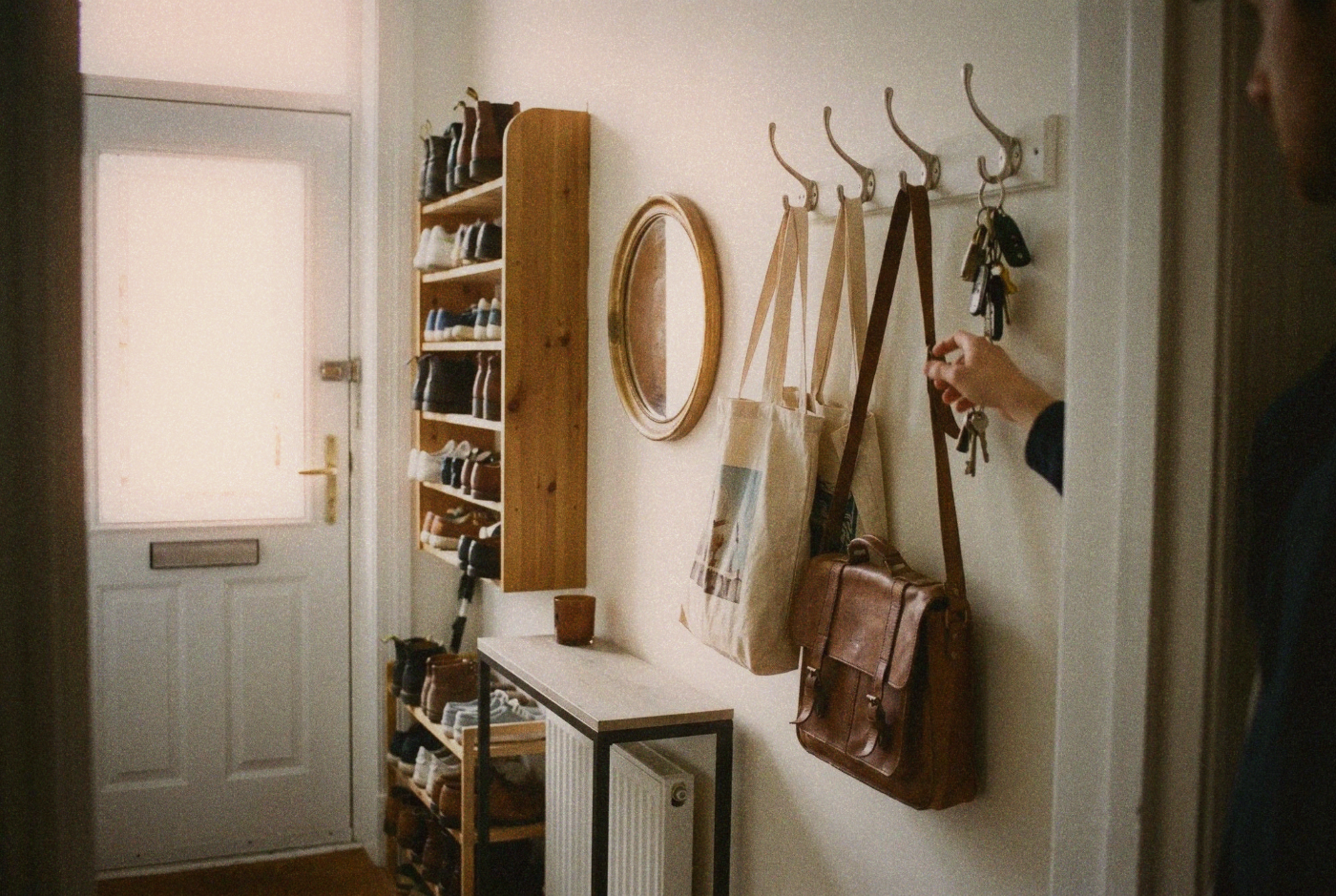 Narrow apartment entryway with wall-mounted shoe rack