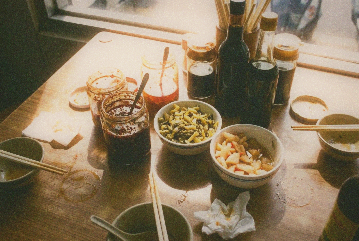 Close-up of condiment table at a Taiwanese beef noodle shop