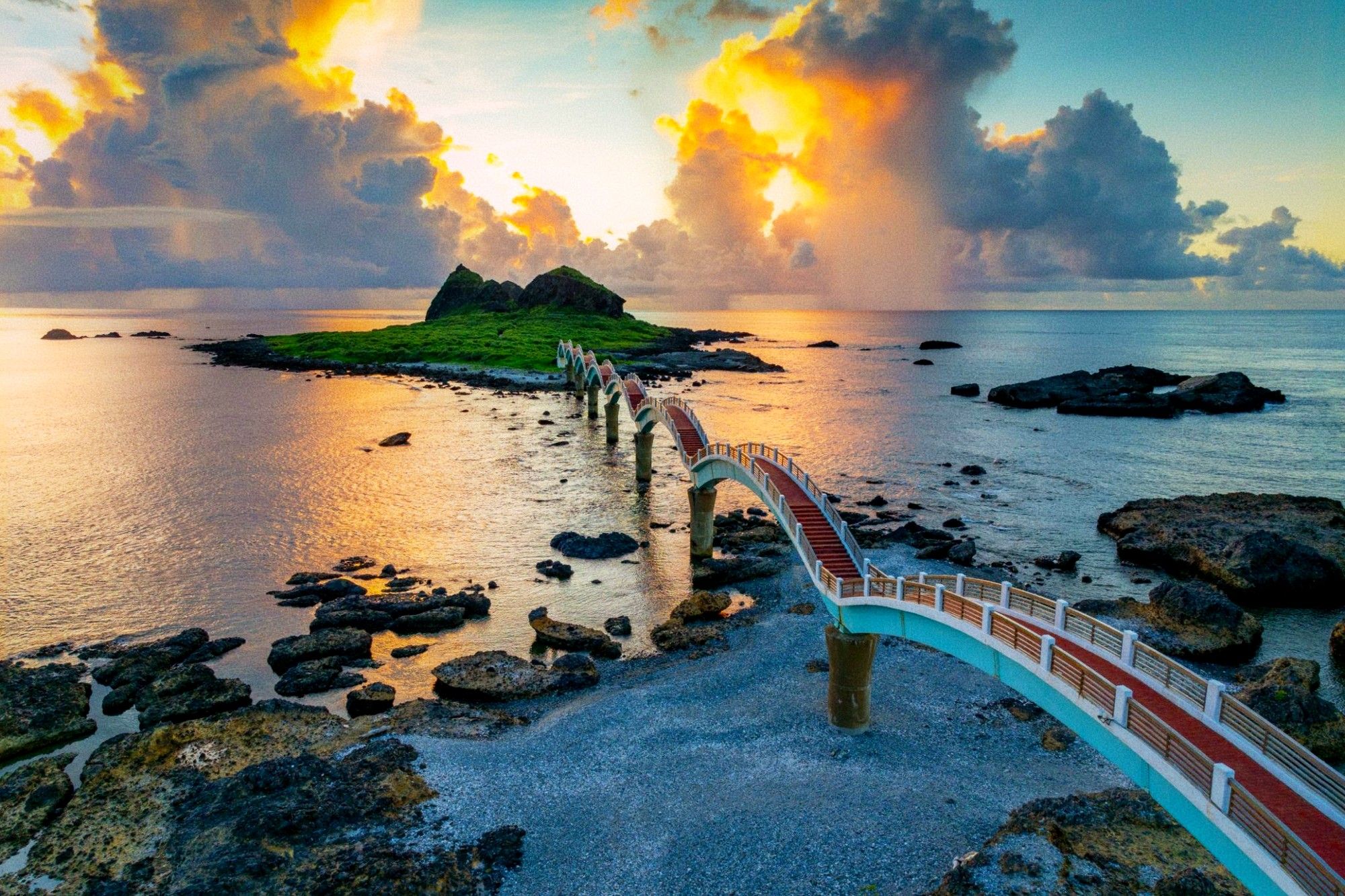 Coastal view of the eight-arch bridge at Sanxiantai stretching toward a volcanic island