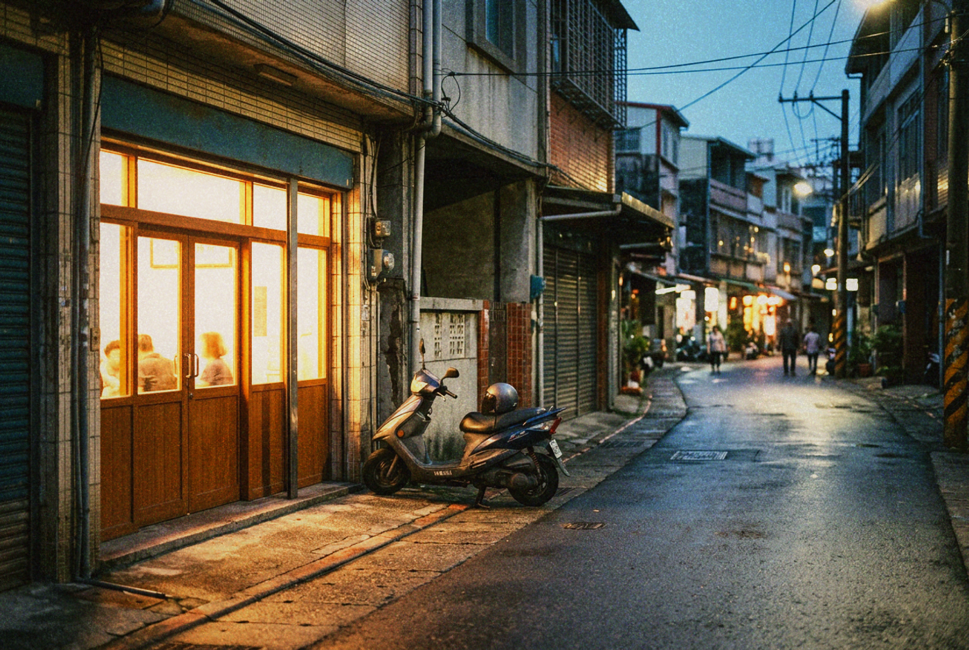 A warmly lit neighbourhood clinic glowing onto a quiet Taiwan street at dusk, a scooter parked outside