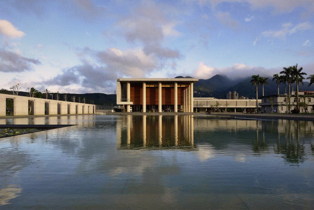 A quiet temple courtyard in the early morning, stone and water, soft light