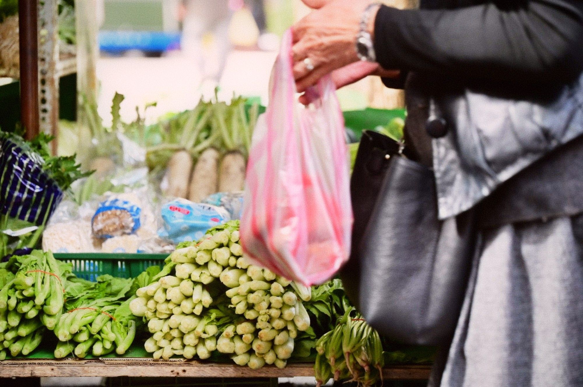 Bundles of fresh vegetables at a wet market stall, arranged for sale