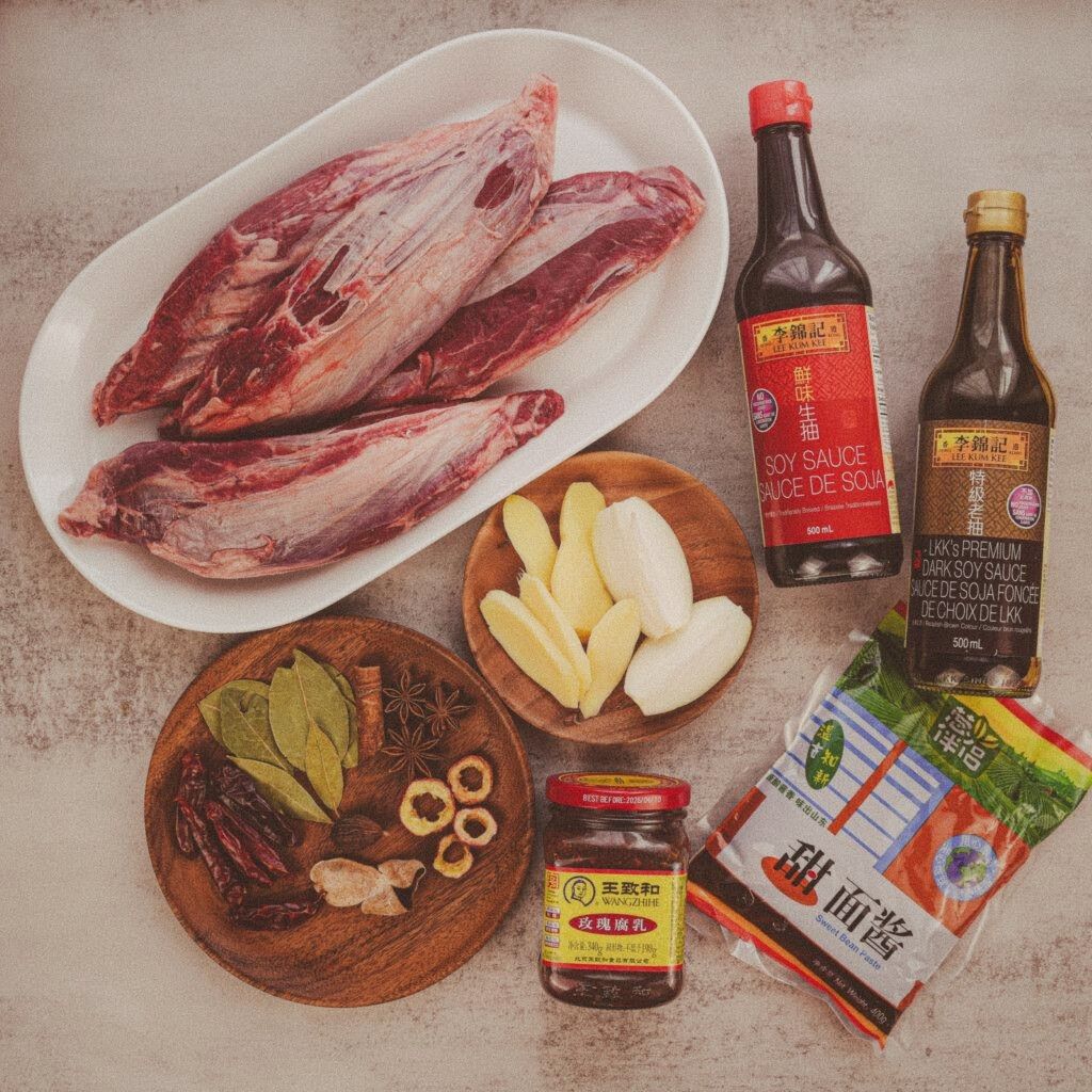 Ingredients laid out: beef shank, doubanjiang, star anise, scallions, ginger, soy sauce