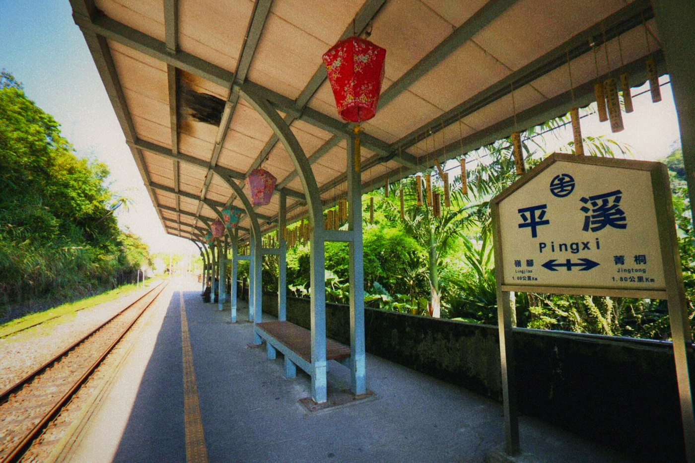Red lanterns hang above the platform at Pingxi Station.