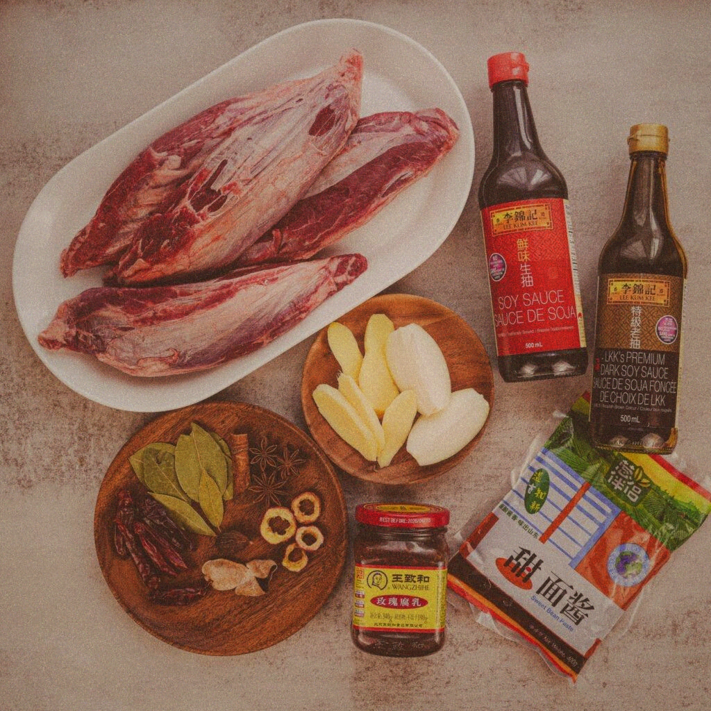 Ingredients laid out: beef shank, doubanjiang, star anise, scallions, ginger, soy sauce