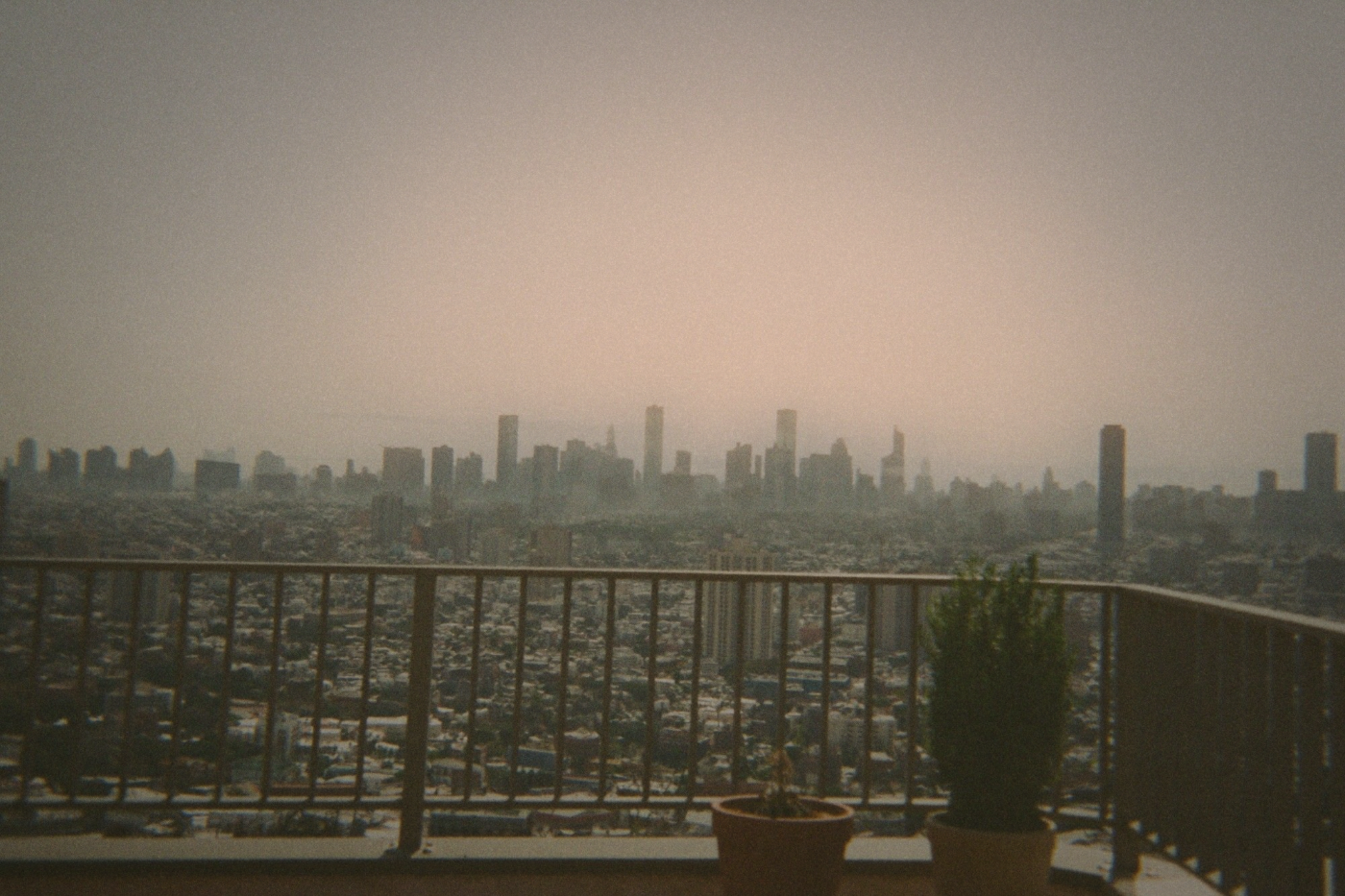 Panoramic view of Taipei cityscape on a hazy day seen from a rooftop