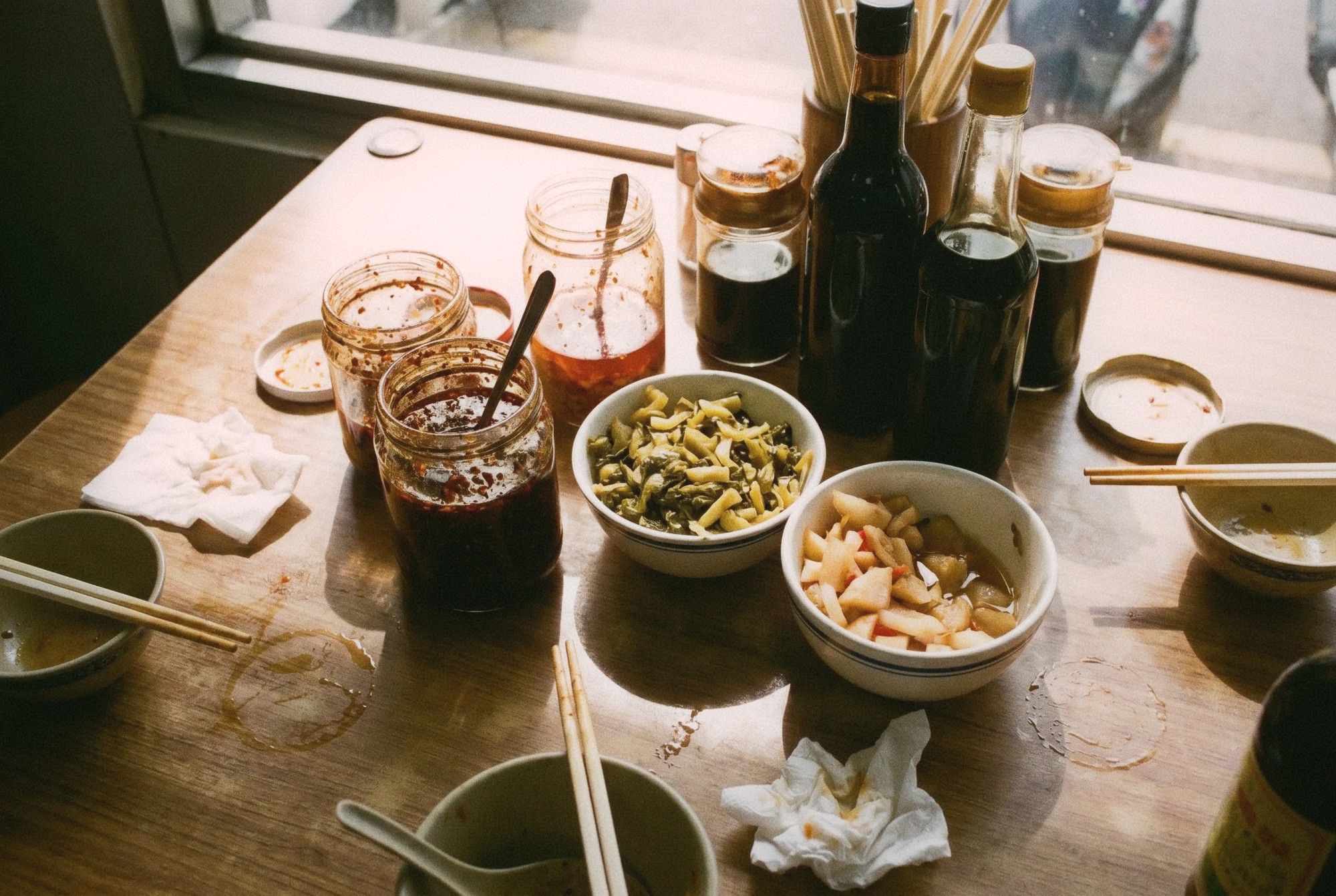 Close-up of condiment table at a Taiwanese beef noodle shop