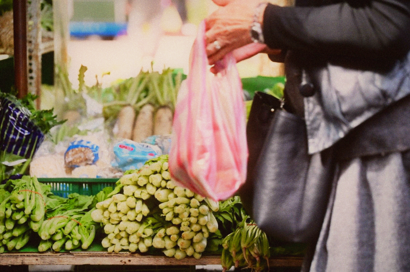Bundles of fresh vegetables at a wet market stall, arranged for sale