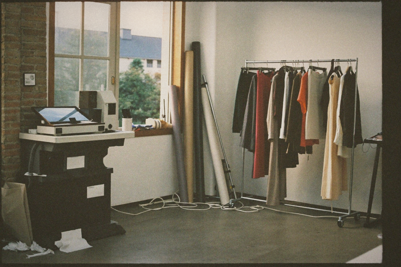 Garment patterns and toiles pinned to a studio wall in Taipei
