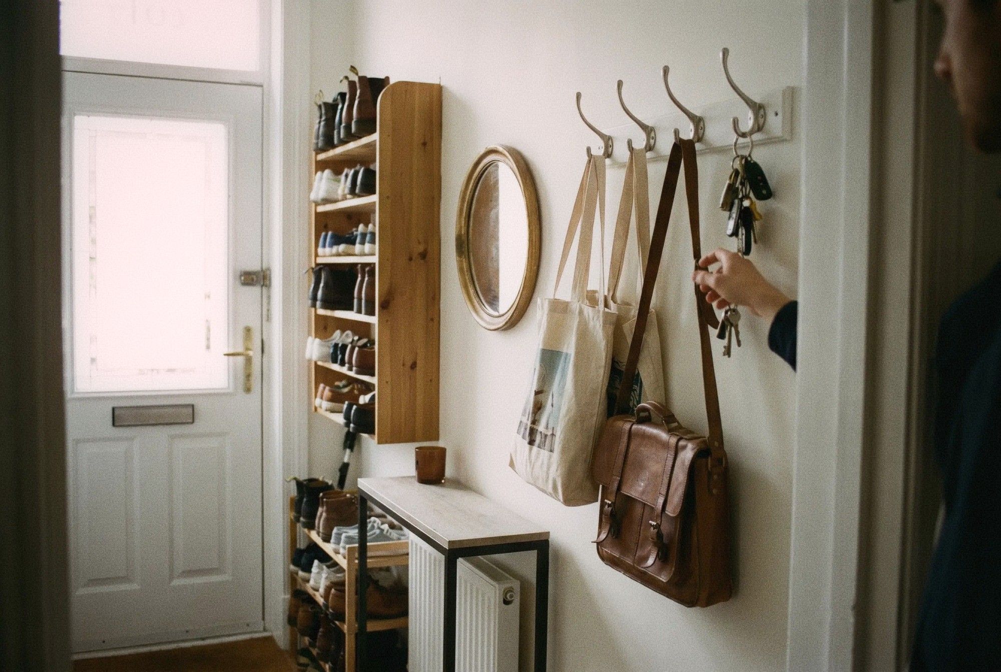 Narrow apartment entryway with wall-mounted shoe rack