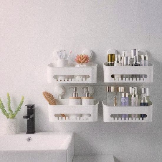 Bathroom wall-mounted storage solutions including suction shelves and an over-toilet rack, showing cleared floor space