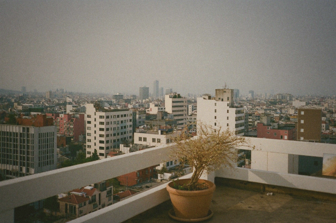 Taipei skyline viewed from a balcony on an overcast day with reduced visibility