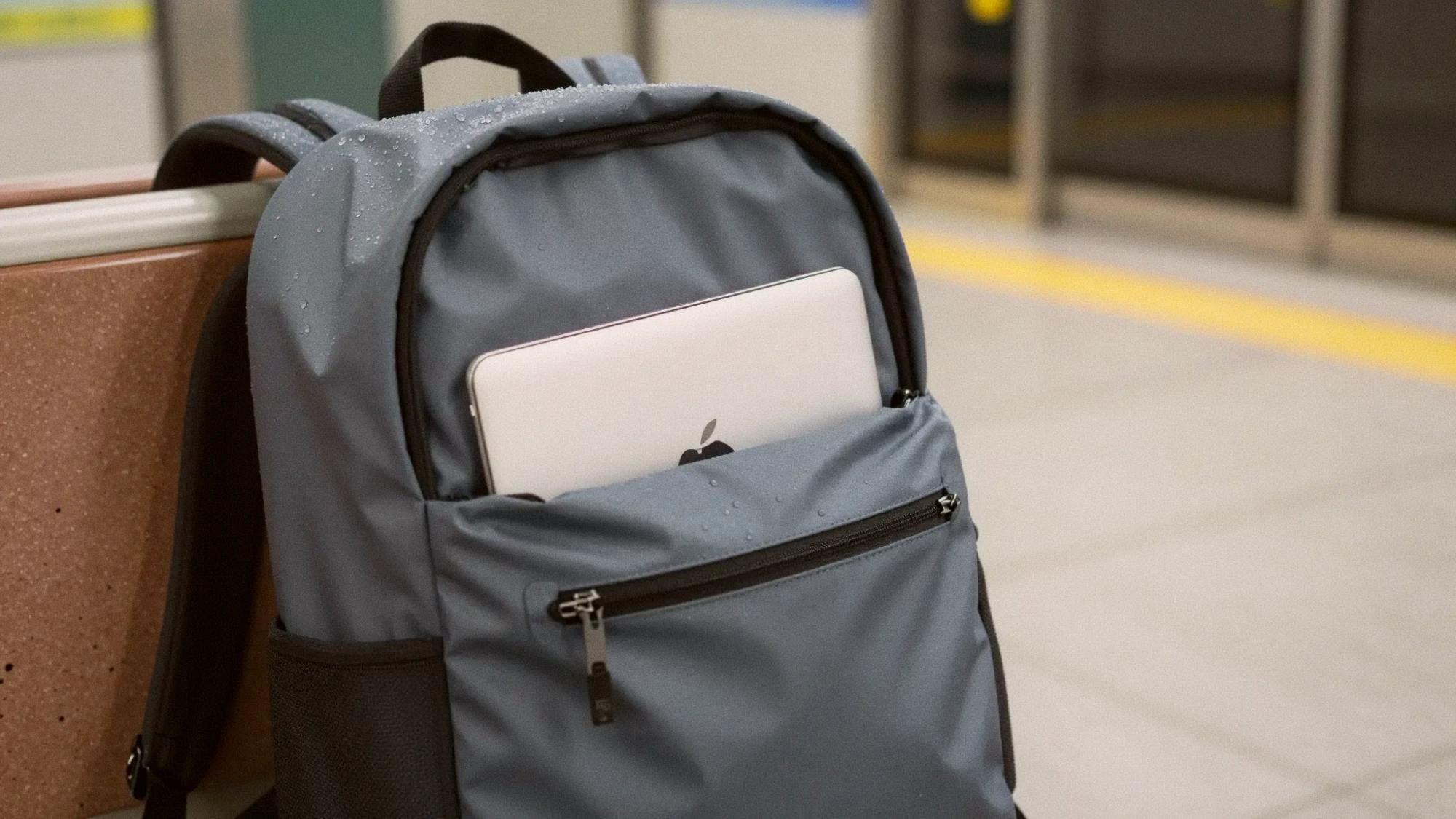 Close-up of a waterproof backpack with rain droplets beading on its surface