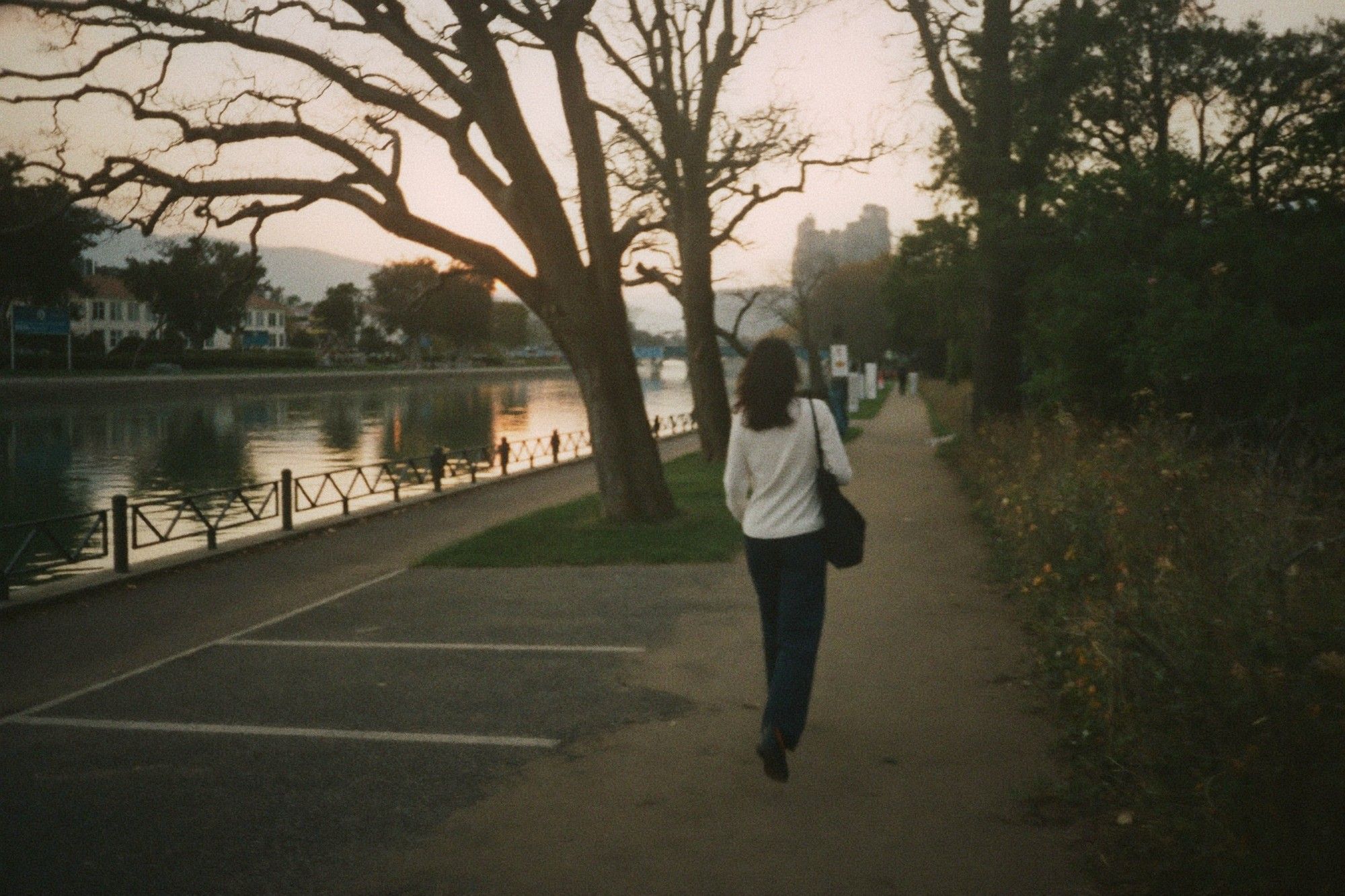 Walking along a riverside path at dawn