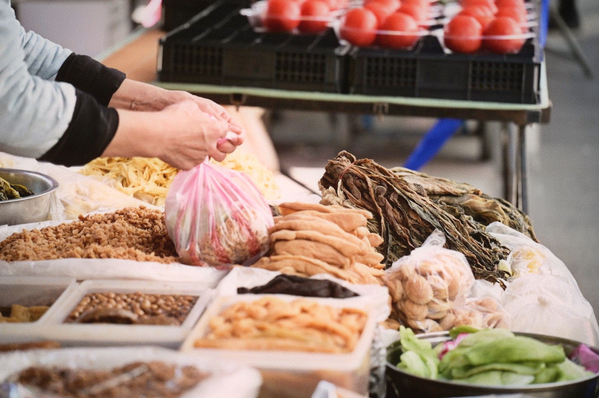 Traditional fermented foods including pickled vegetables and tofu at a market stall