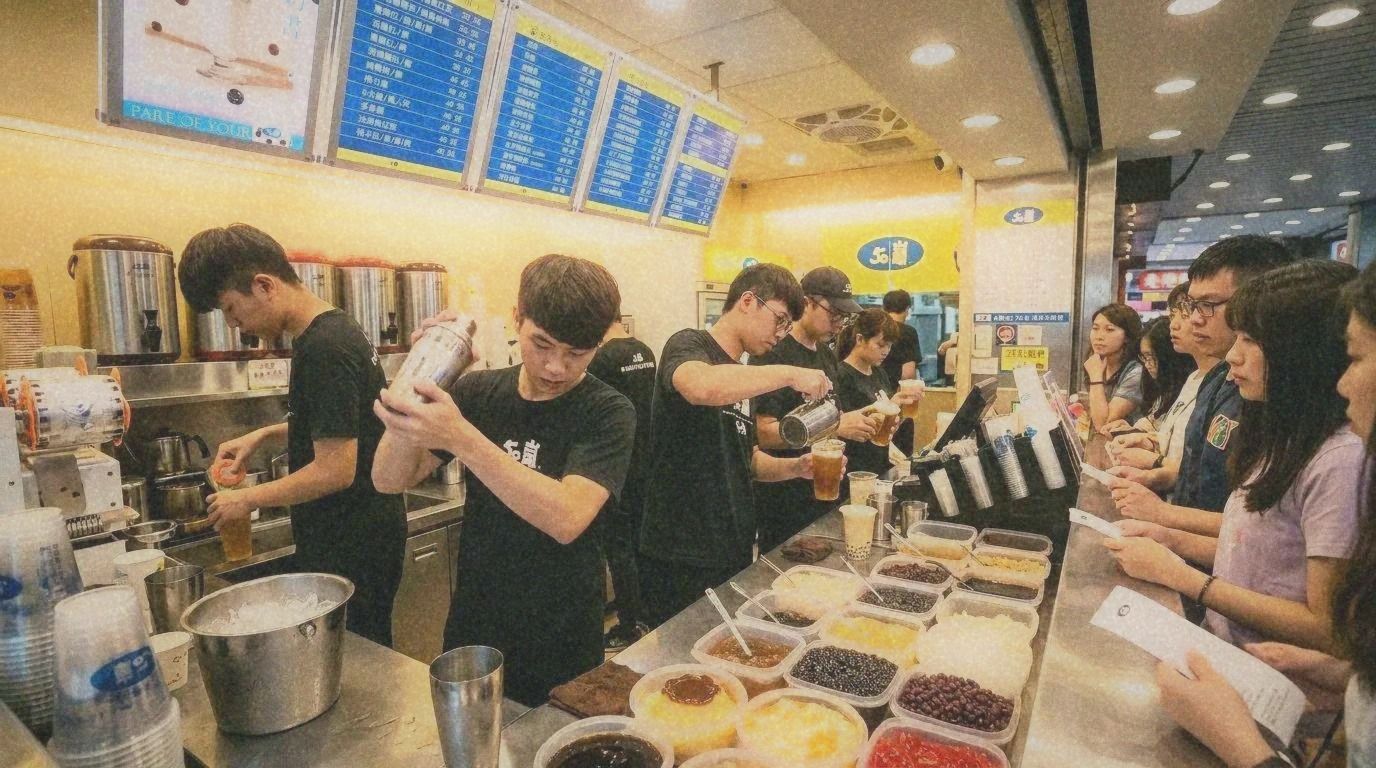 A busy bubble tea shop counter in Taipei with drinks being prepared