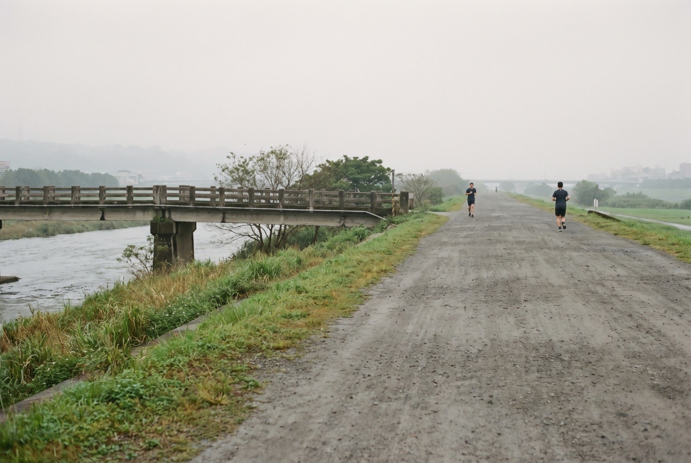 Illustration: Runners on an overcast riverside morning.