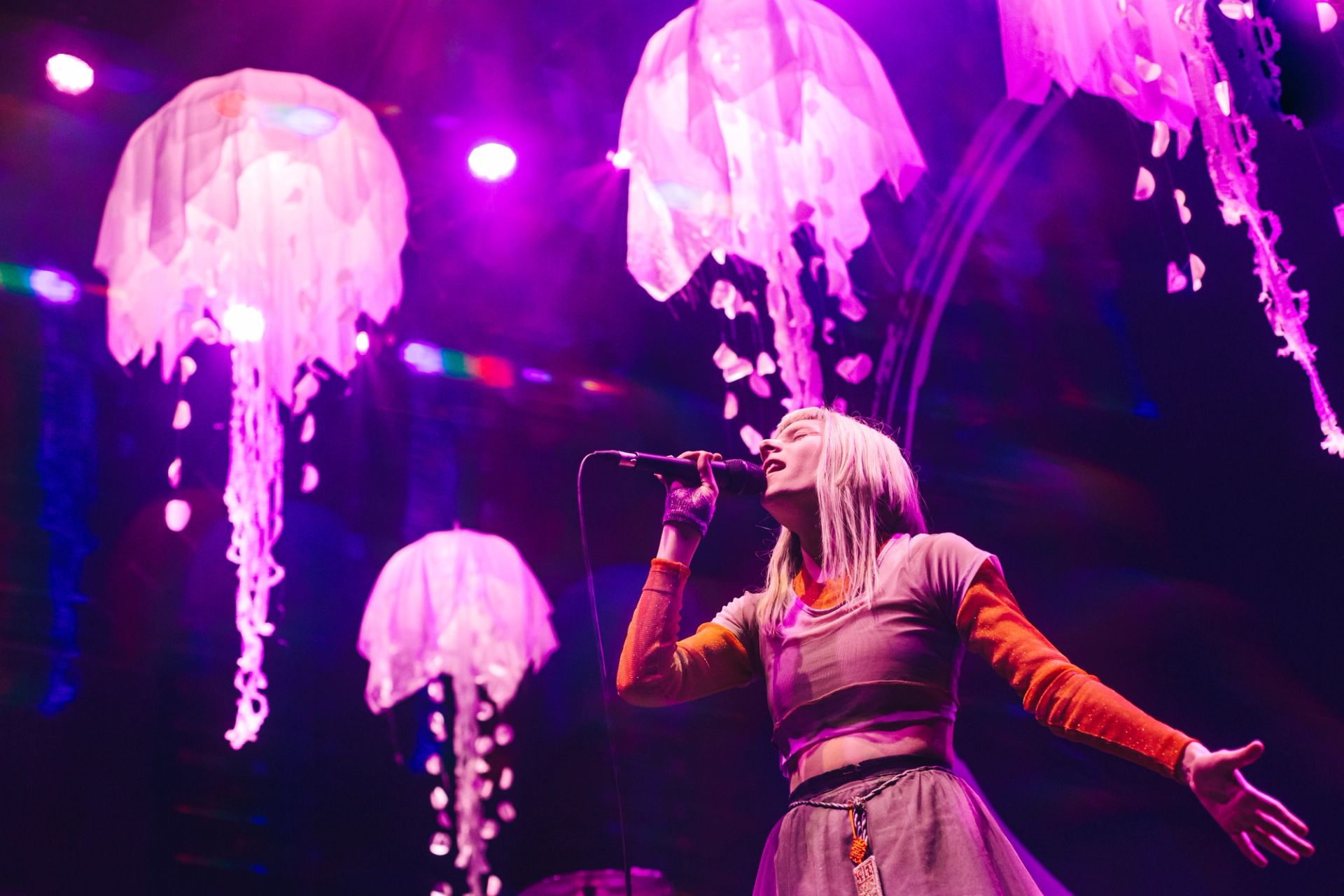 Singer Aurora performing live singing into a microphone live in Mexico city - Photographed by Alan Cortés
