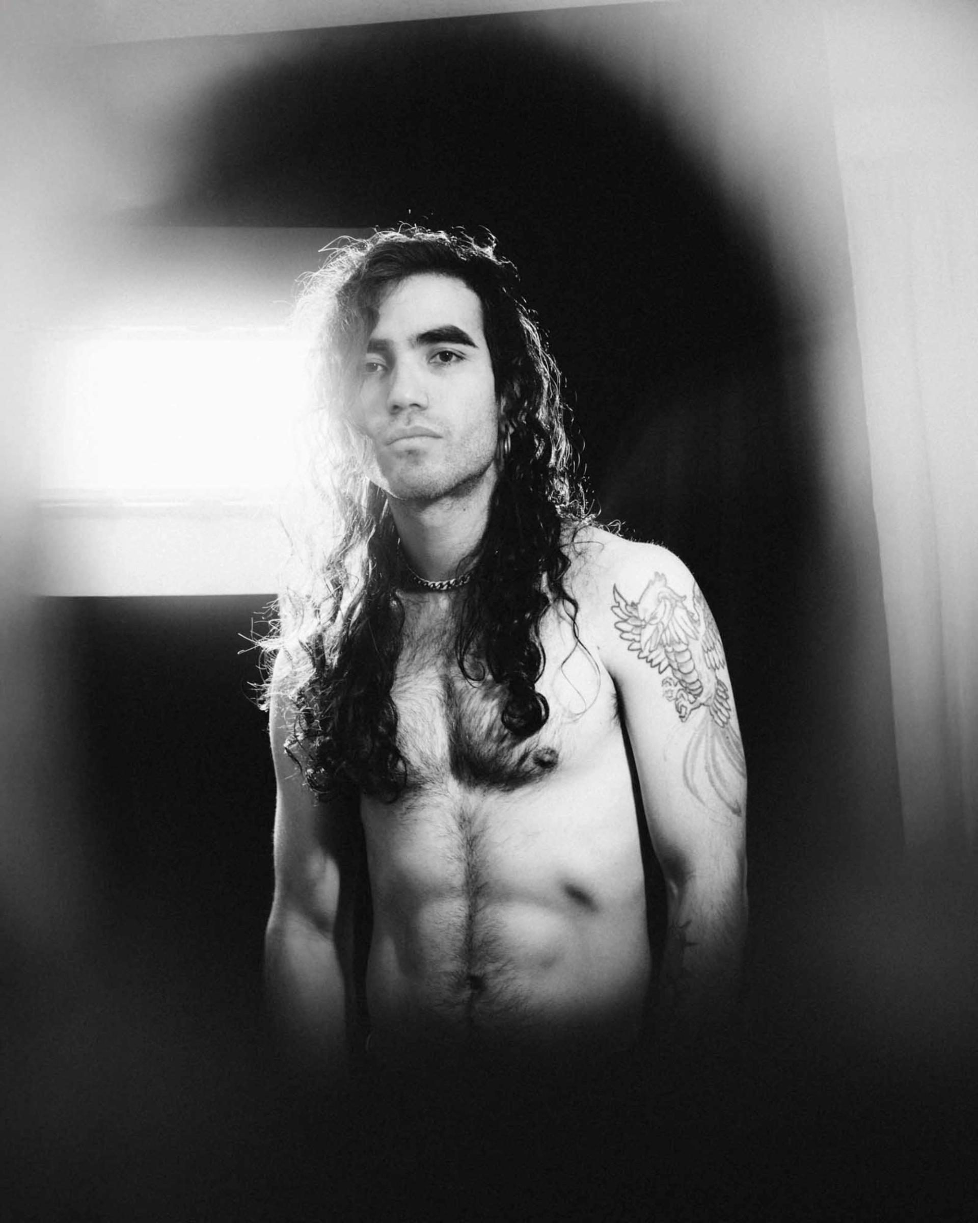 Black and white portrait of mexican artist Almatriste, dramatic lighting, stylized, no t shirt, photographed by Alan Cortès in Mexico City