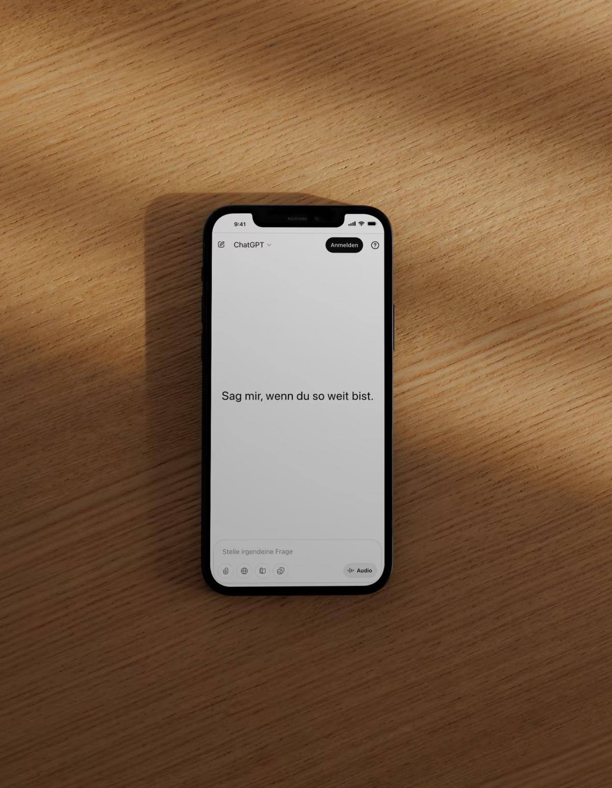 Smartphone mit ChatGPT auf einem Holztisch