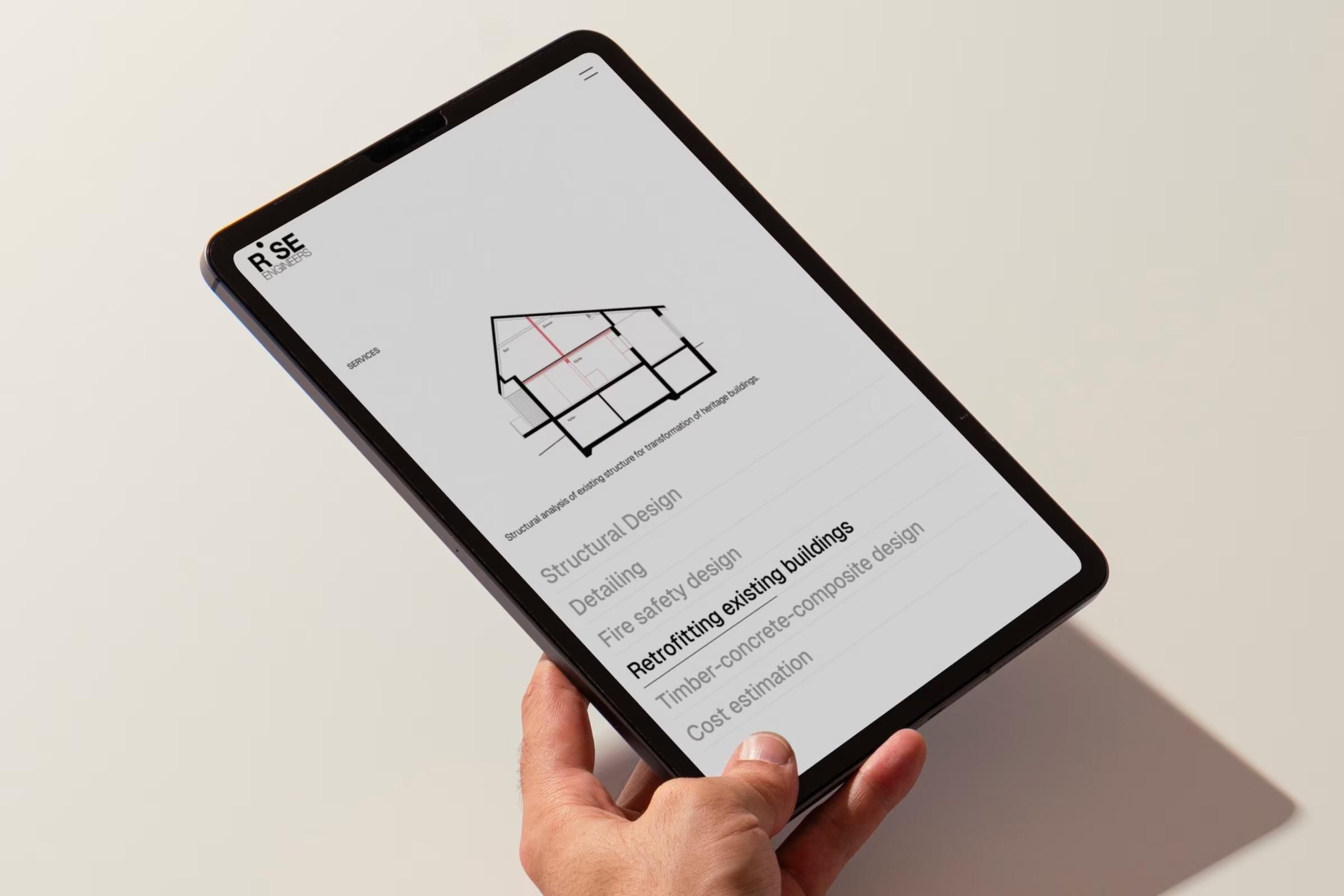 Hand hält ein Tablet mit den Leistungen von RISE Engineers und einer Schnittzeichnung