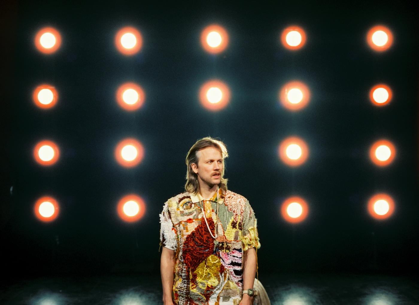 Forestilingsbilde. Fredrik Høyer foran en lysvegg