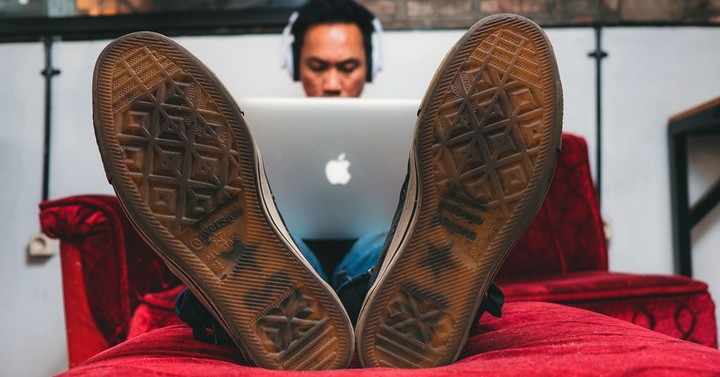 Illustration of a freelancer at a laptop earning money from independent client projects