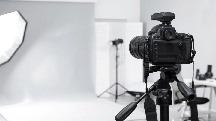 Illustration of a photographer with camera surrounded by income stream icons and dollar signs
