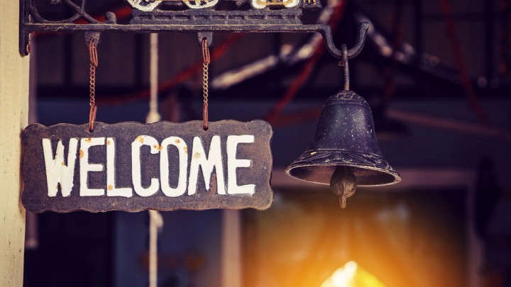 Illustration of a welcome email envelope opening with a friendly greeting to new subscribers